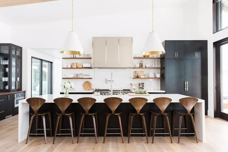 Long kitchen island with two oversized pendants.