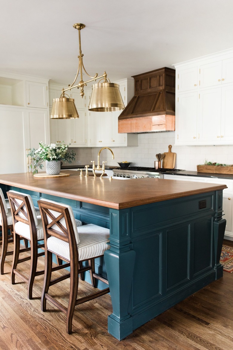 Gold industrial chandelier above traditional kitchen island