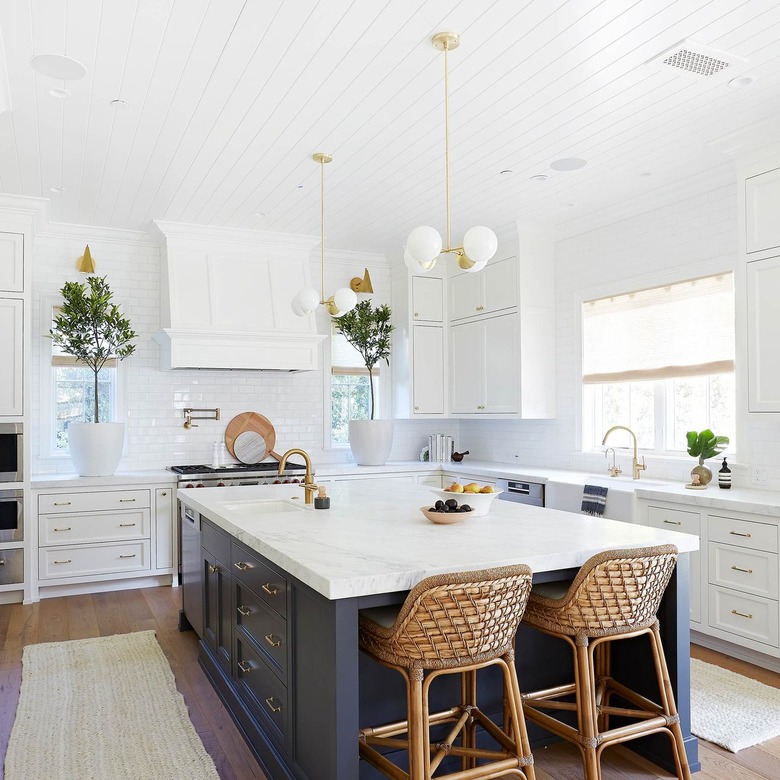 two globe style chandeliers above blue and white island