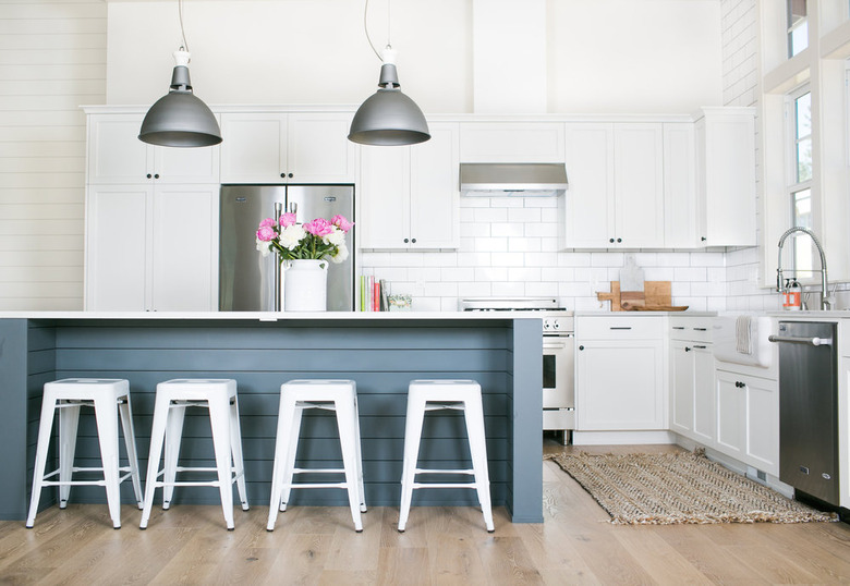 kitchen island lighting idea with factory style pendants and blue island