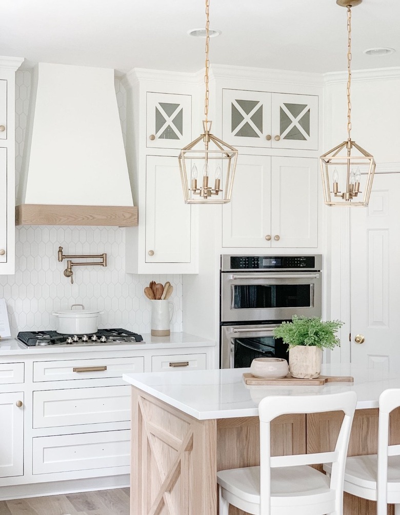 brass vintage style lanterns in white kitchen above island
