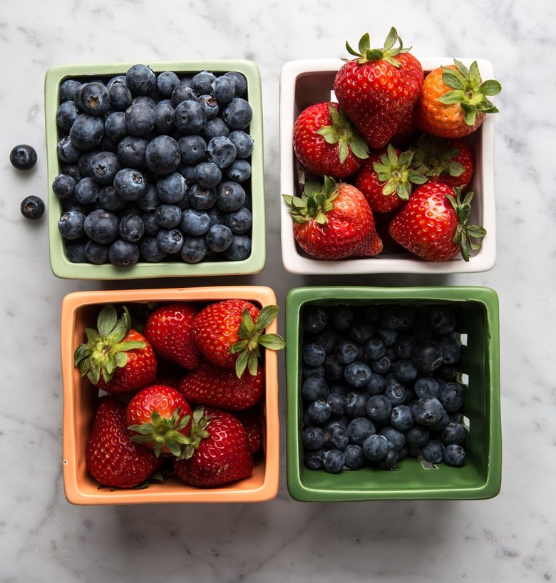 Berries in different ceramic baskets