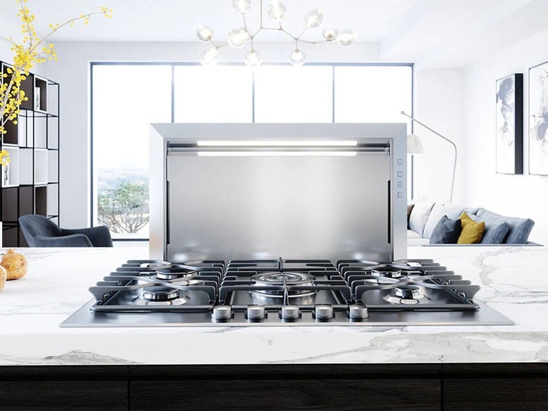 A Zephyr downdraft vent hood on a quartz kitchen countertop with a gas range