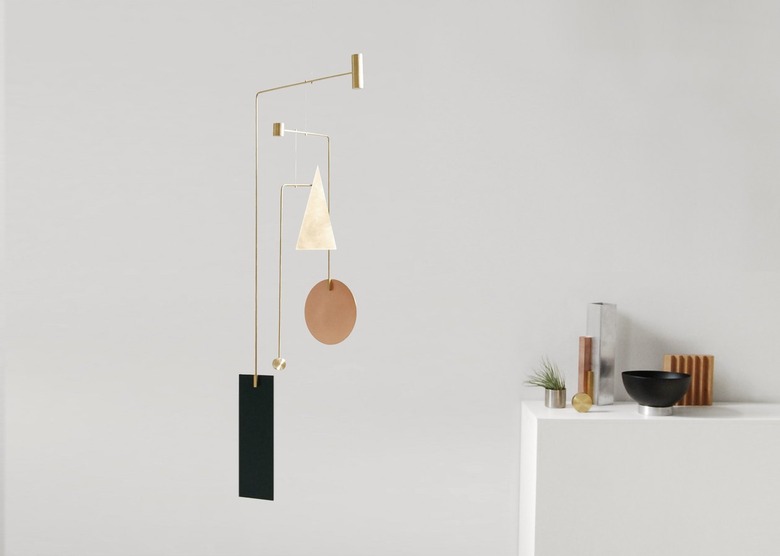 A mobile of geometric shapes made of brass