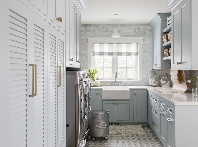 Laundry room with light blue cabinets