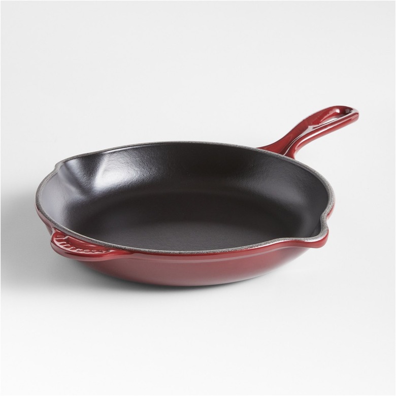 Le Creuset Classic 9 Rhône Enameled Cast Iron Skillet in a dark red color with a gold knob
