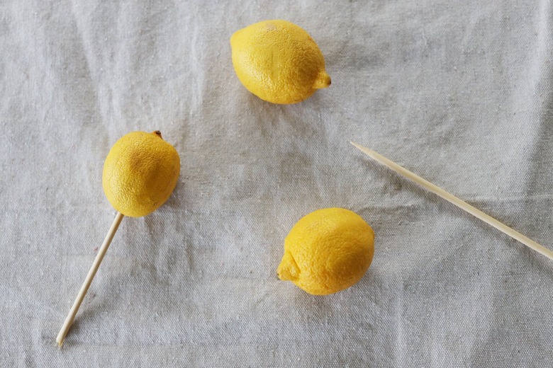 Wooden skewer inserted into lemon