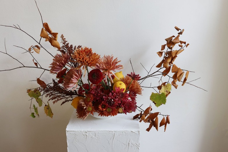 Lemons added to foraged floral arrangement