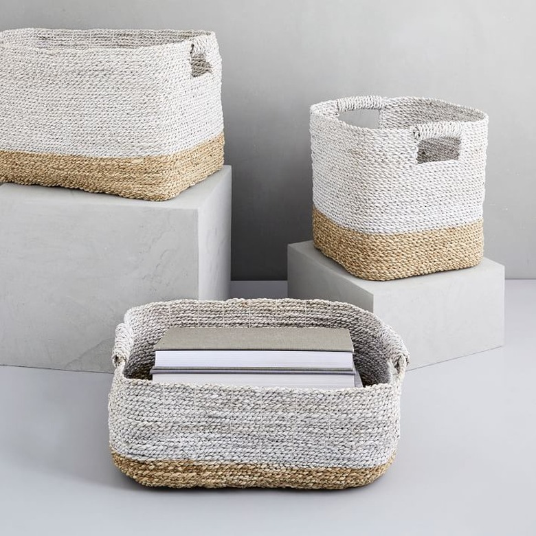 Woven storage baskets with handles in various sizes. Bottom 1/4 is beige and top 3/4 is light gray