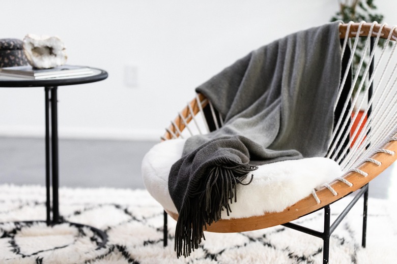 living room furniture idea with woven accent chair and side table on area rug