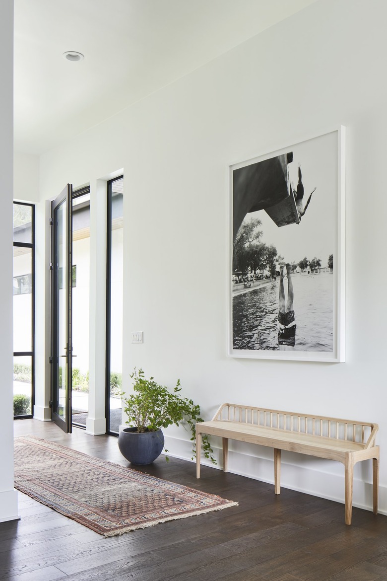 front entry area with bench and framed artwork