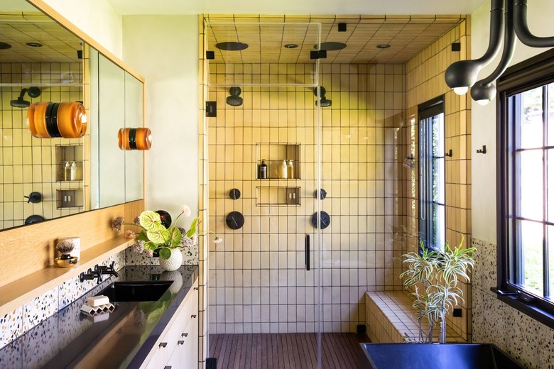 primary bath with large walk-in shower and trough style sink at vanity