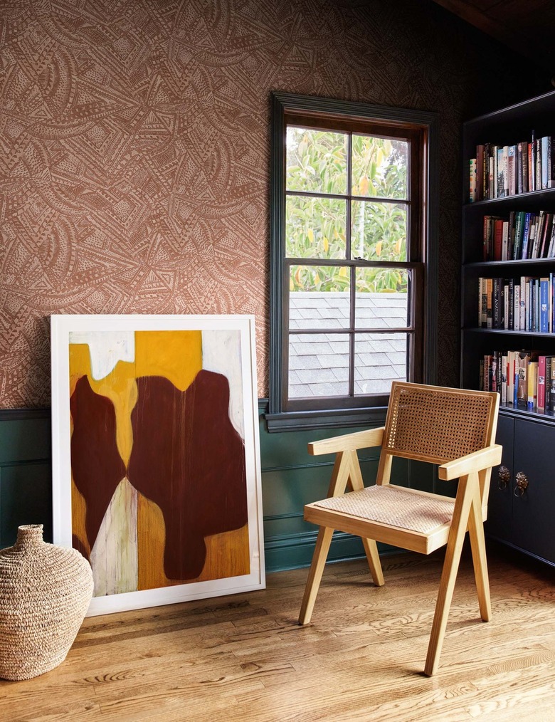 patterned wallpaper with artwork and chair