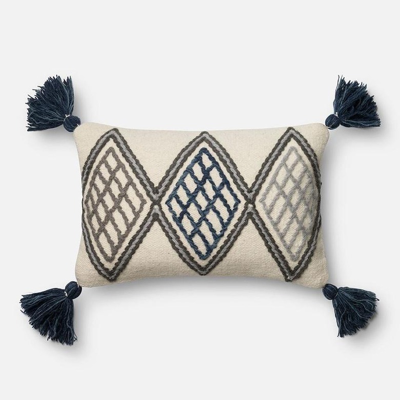 black and white patterned pillow with tassels