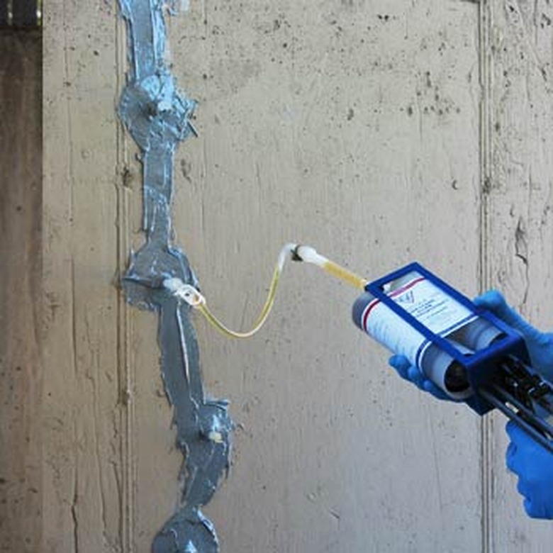 Two-part urathane foam injected behind crack.