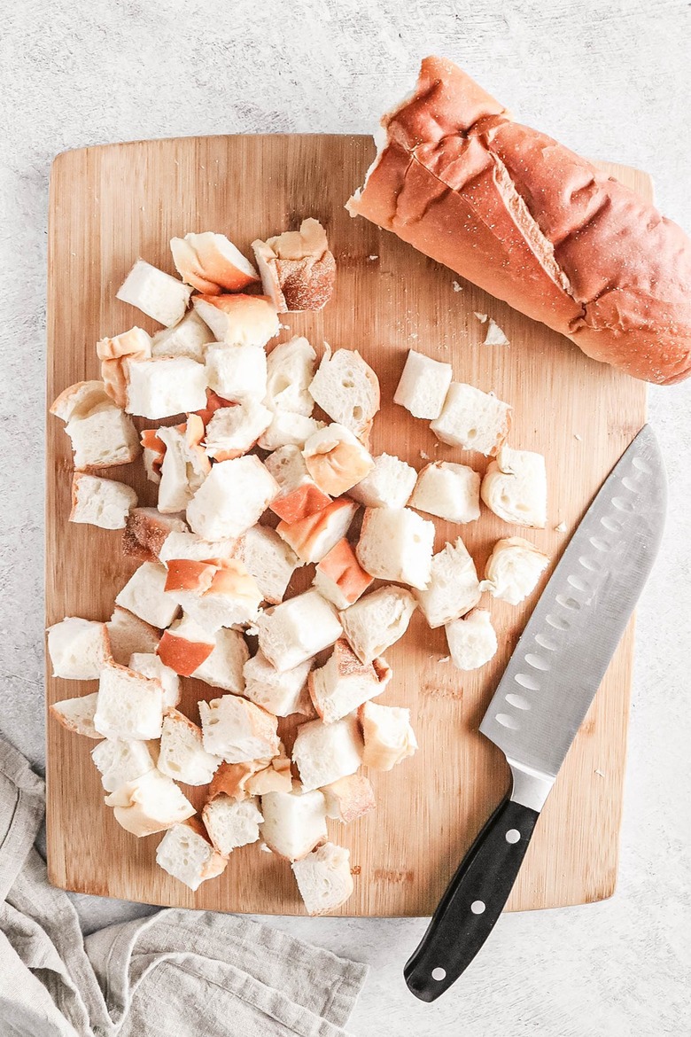 Cubes of bread on a wooden cutting board
