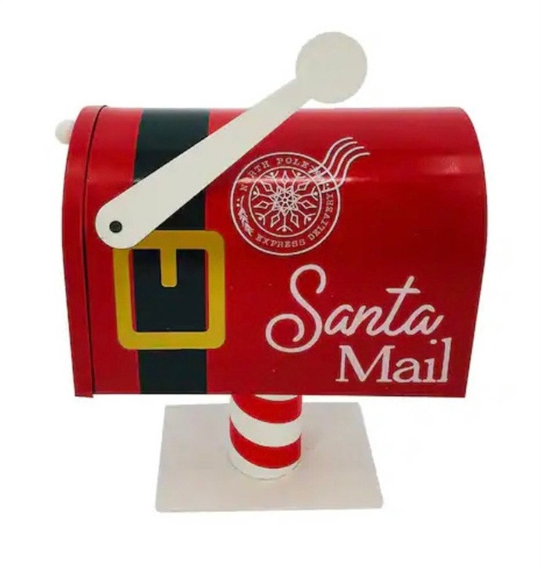 A red mail box with a white flag. The mailbox has a black belt design with a gold buckle around the front
