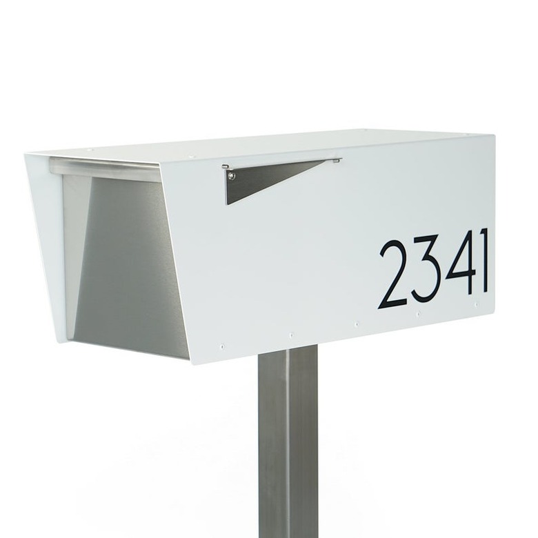 White midcentury modern mailbox with angular details and black house numbers