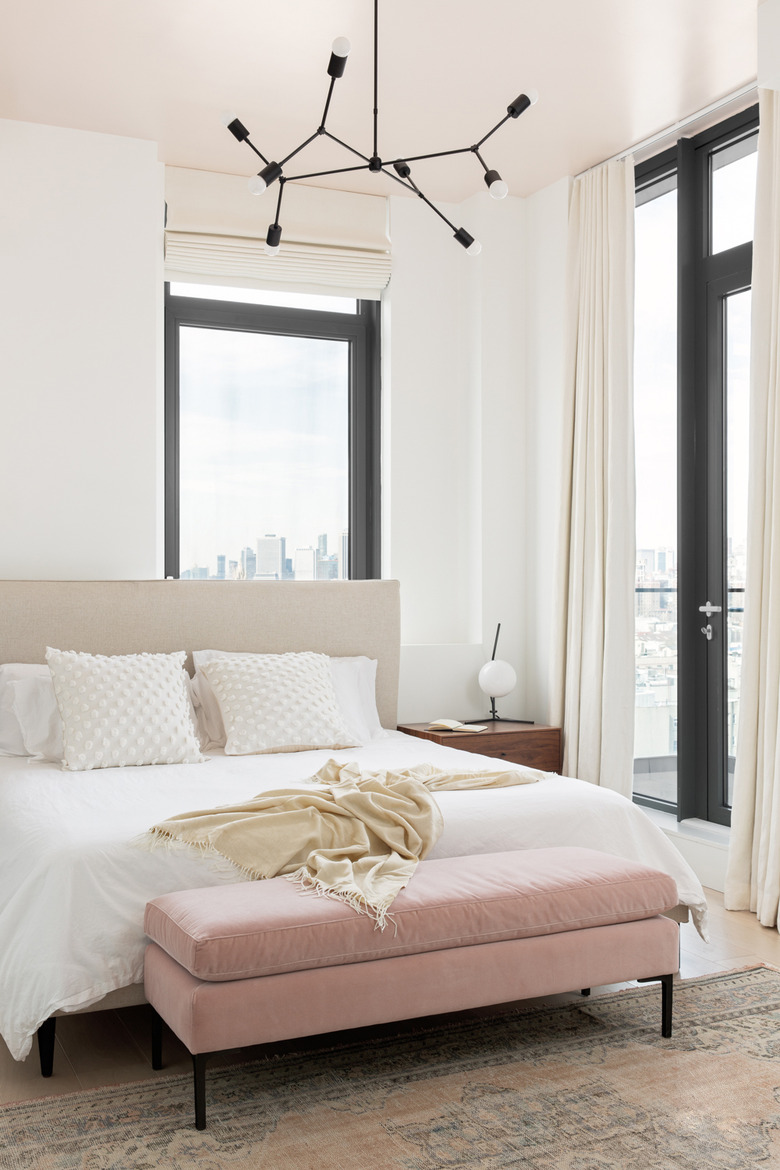 Bedroom with blush pink ottoman