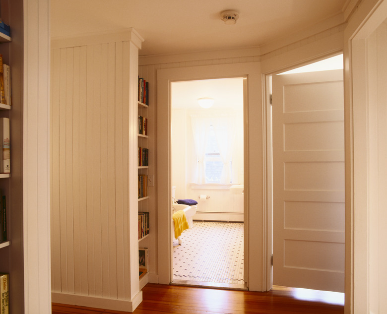 White Beaded Paneling in Hallway Leading to Bathroom