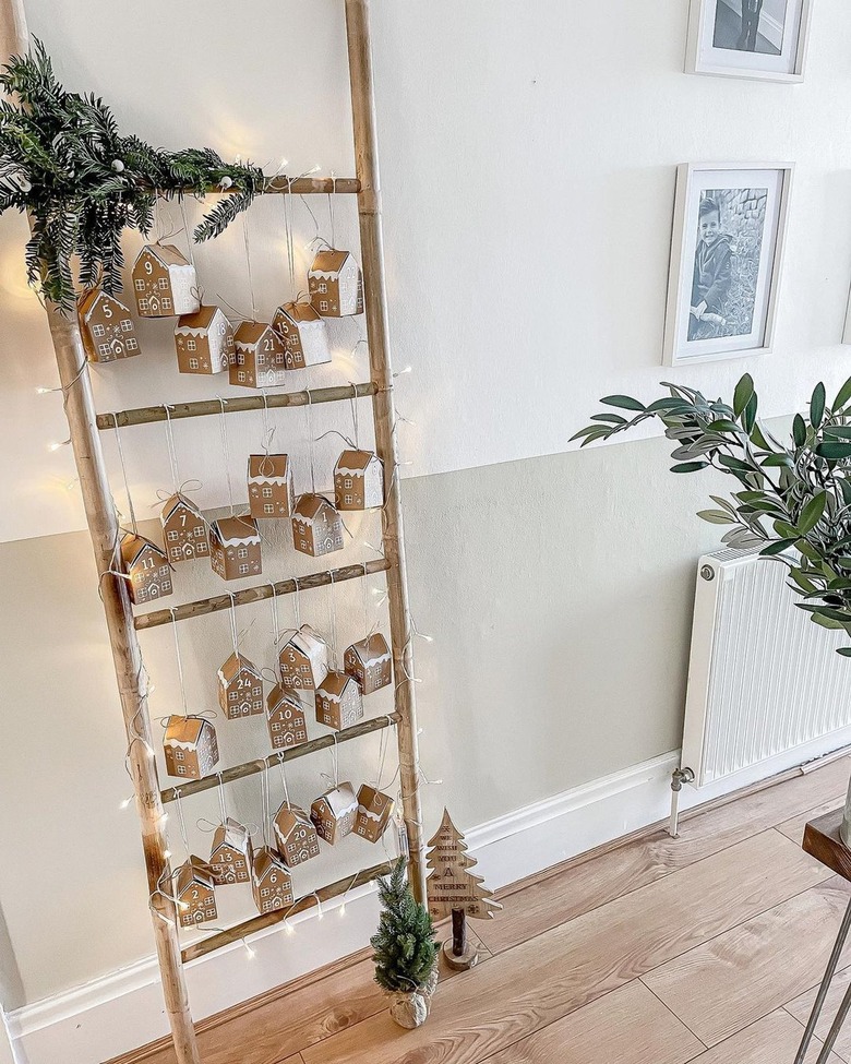 A ladder with cardboard houses as an advent calendar