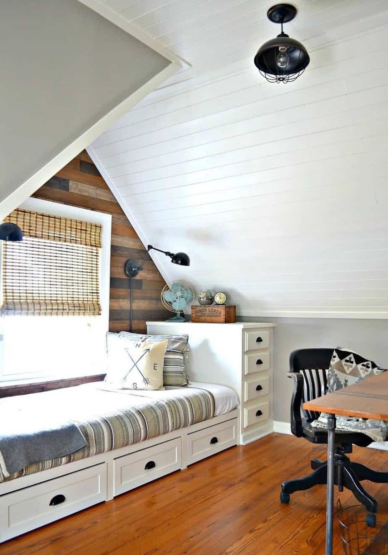 metal wire pendant light on paneled ceiling with built in single bed