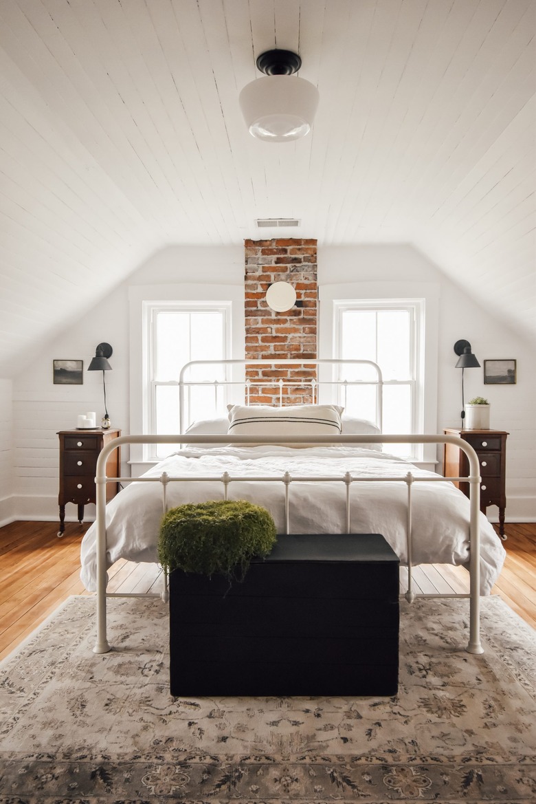 farmhouse bedroom with semi-flush mounted light and black wall lighting