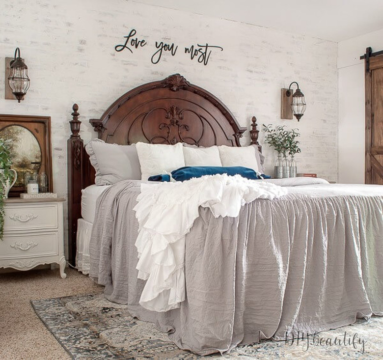 dark wood bed and metal and glass rustic pendant lights