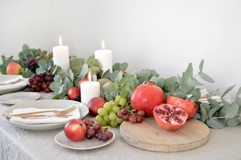 table runner made with eucalyptus and seasonal fruits
