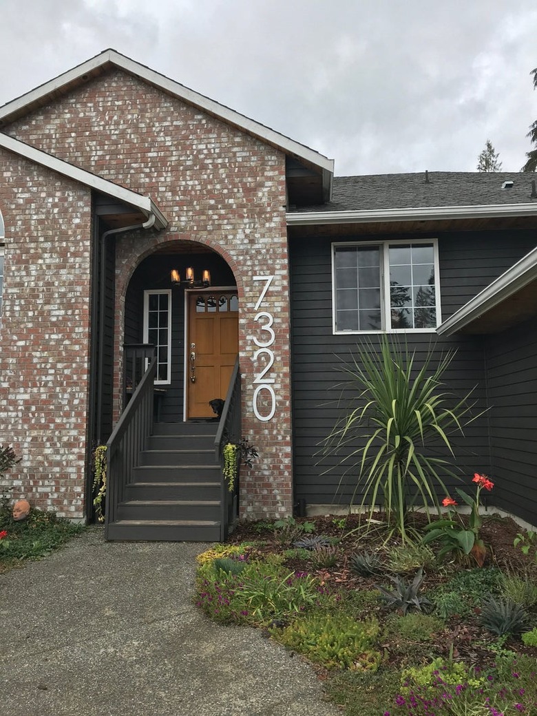oversize modern house numbers on brick exterior