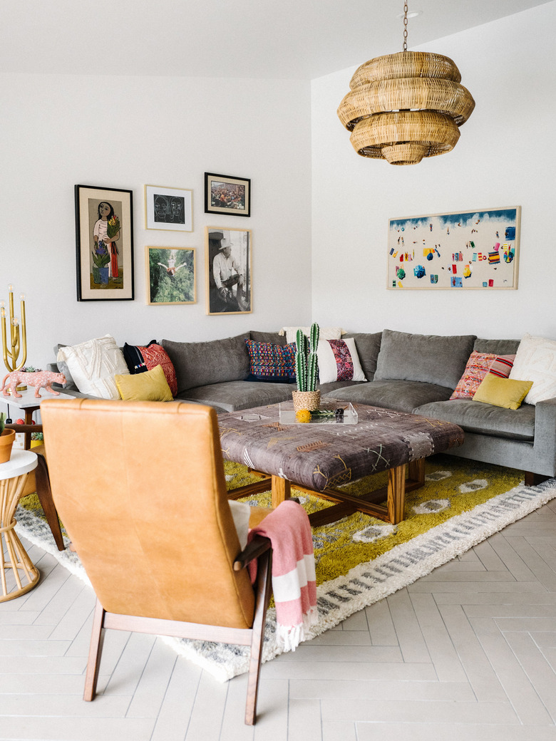 living room lighting idea with natural pendant light above sectional sofa