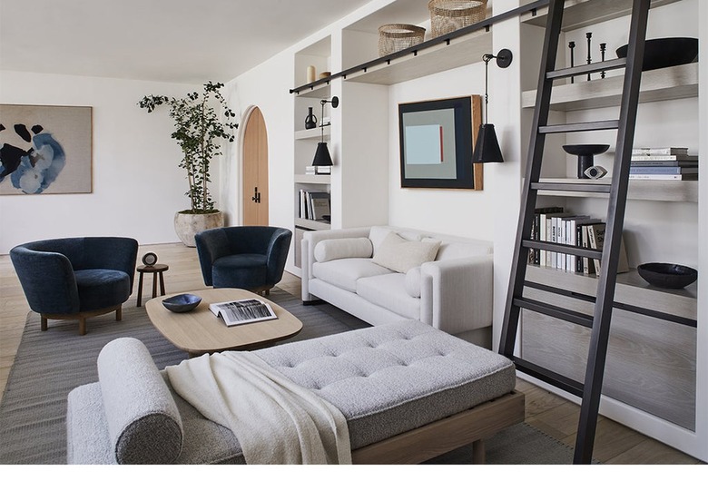 modern living room with a pair of dangling sconces