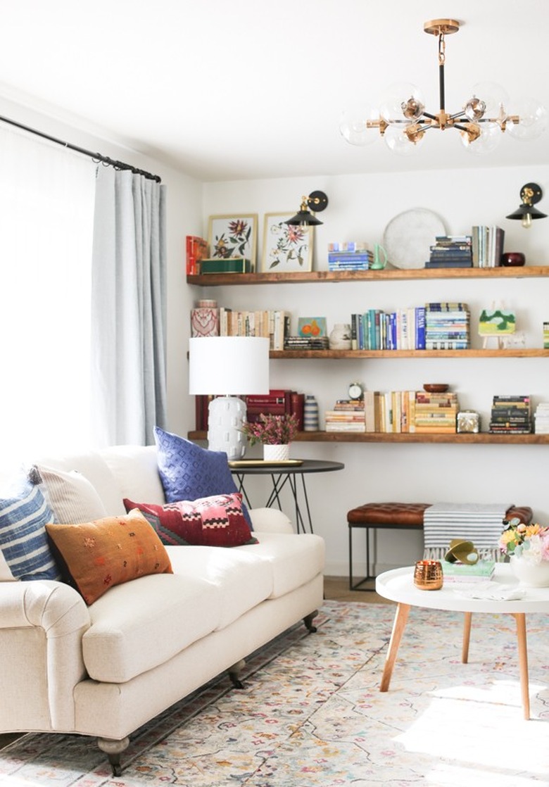 living room lighting idea with small chandelier above coffee table and sofa