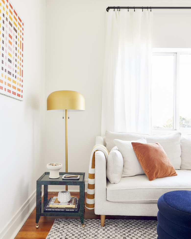 living room lighting idea with gold floor lamp and white sofa