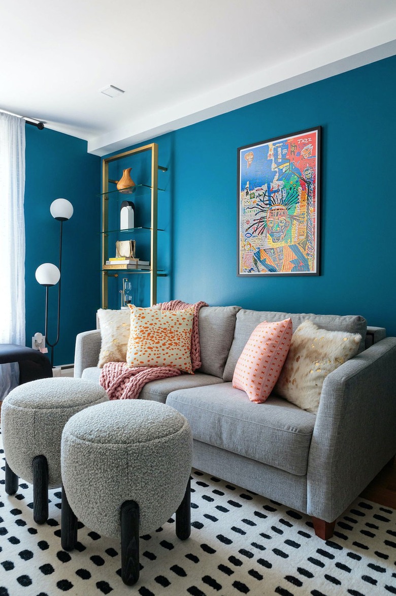 blue and gray living room with U shaped floor lamp.
