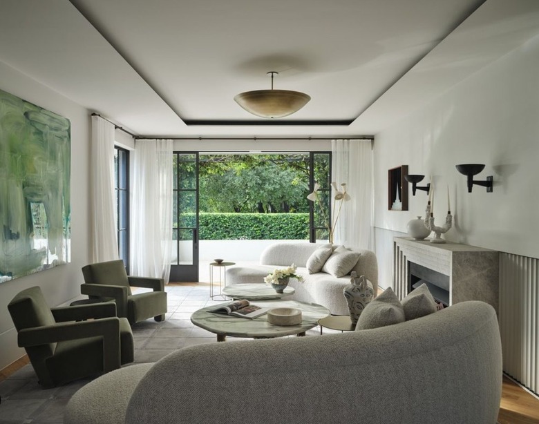 calming living room with gold pendant and pair of black sconces