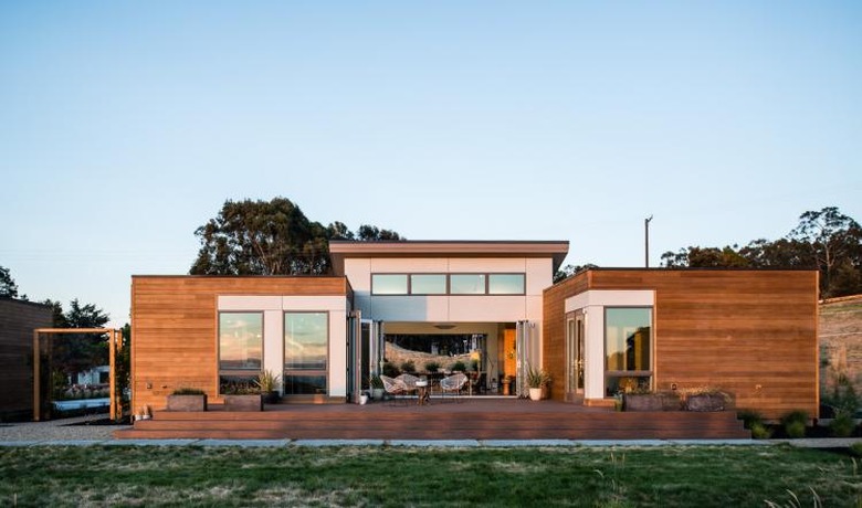 Modern prefab home in warm woods with a flat roof