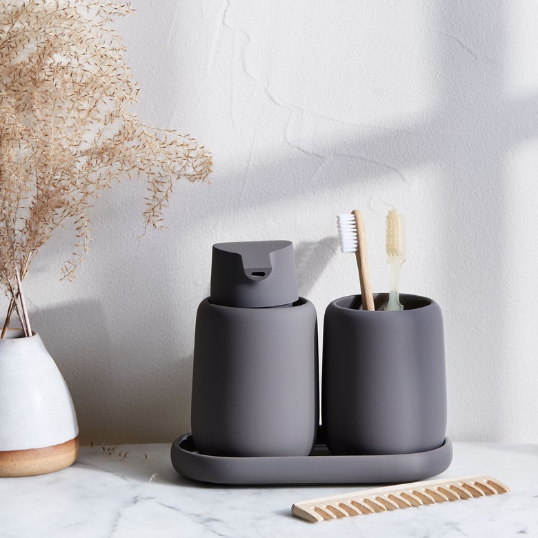 Dark gray bathroom accessories in modern bathroom with tumbler for toothbrush holder