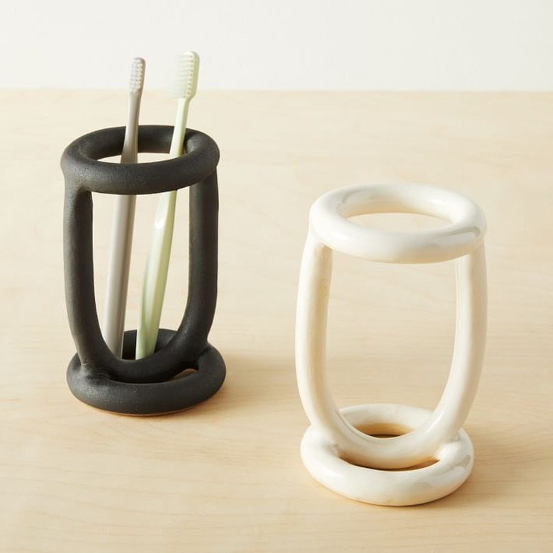 Sculptural toothbrush holders in black and white