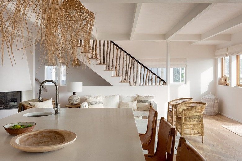 Organic modern kitchen and great room with woven boho light fixtures.