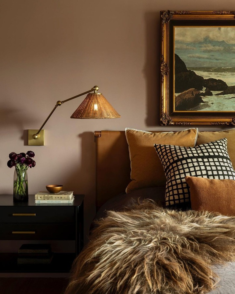 Bedroom in shades of mustard and blush with fur throw