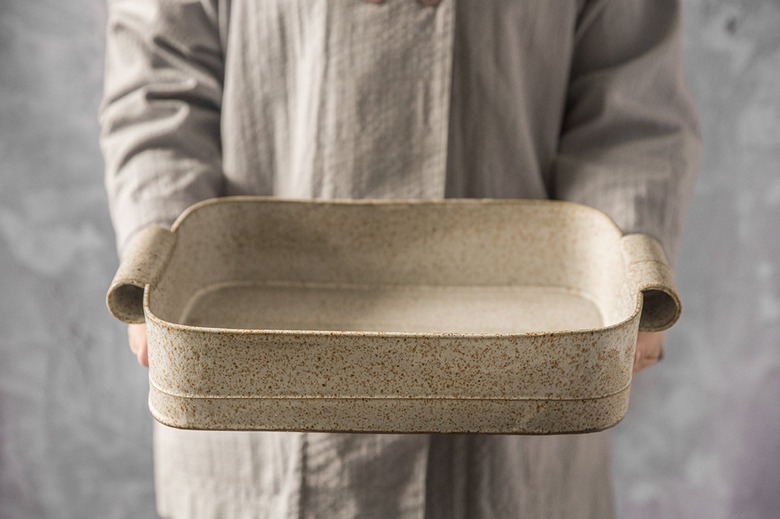person holding ceramic bakeware