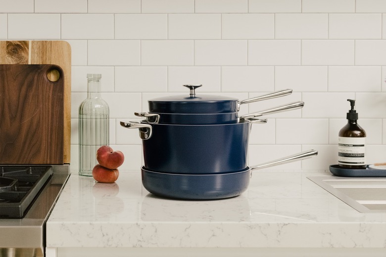 blue ceramic pots and pans stacked on a kitchen counter