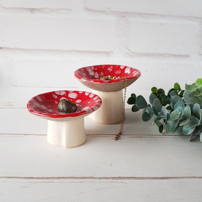 two red mushroom-shaped jewelry holders