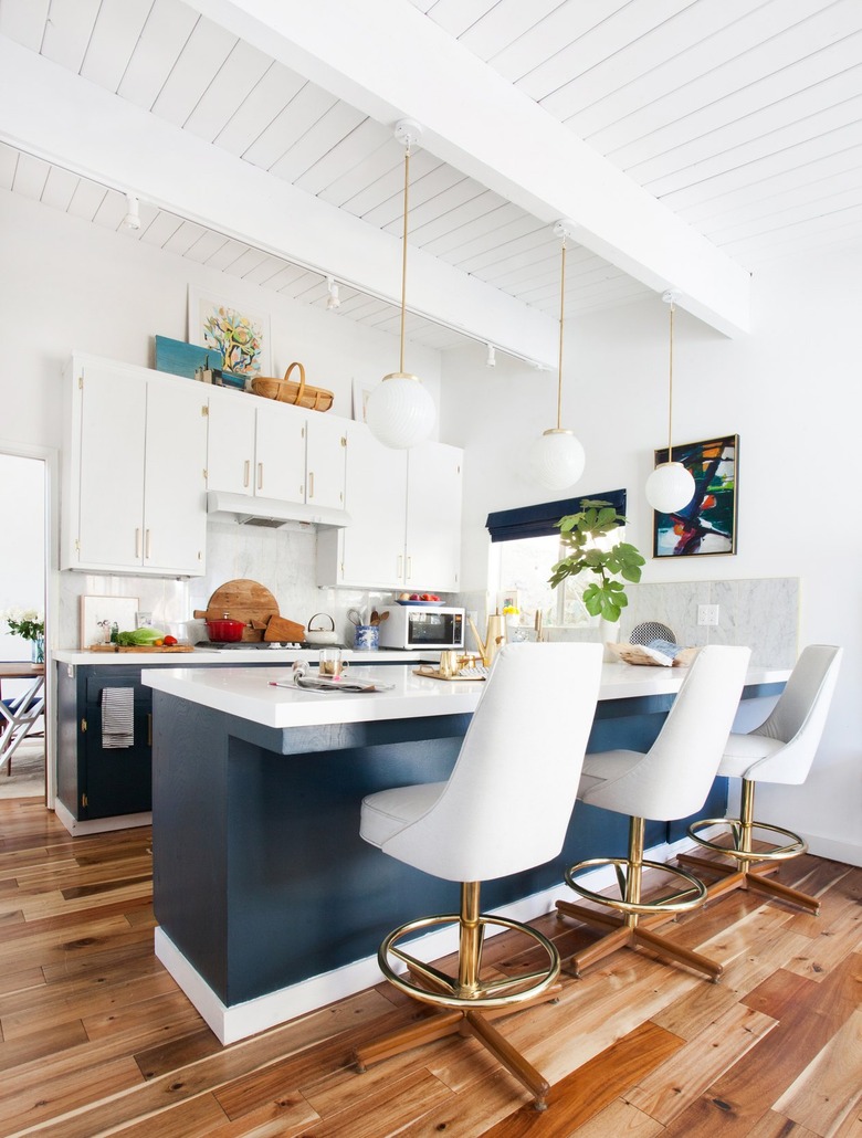 blue and white midcentury kitchen with vintage bar stools