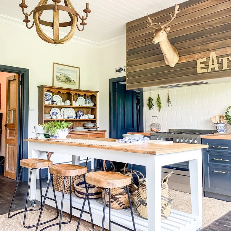 blue cabinets with wood vintage decor and white and wood island