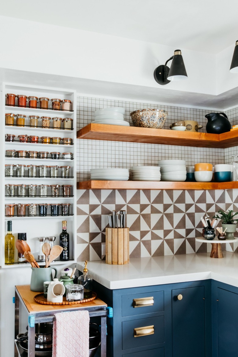 navy blue cabinets with brown and white geometric backsplash