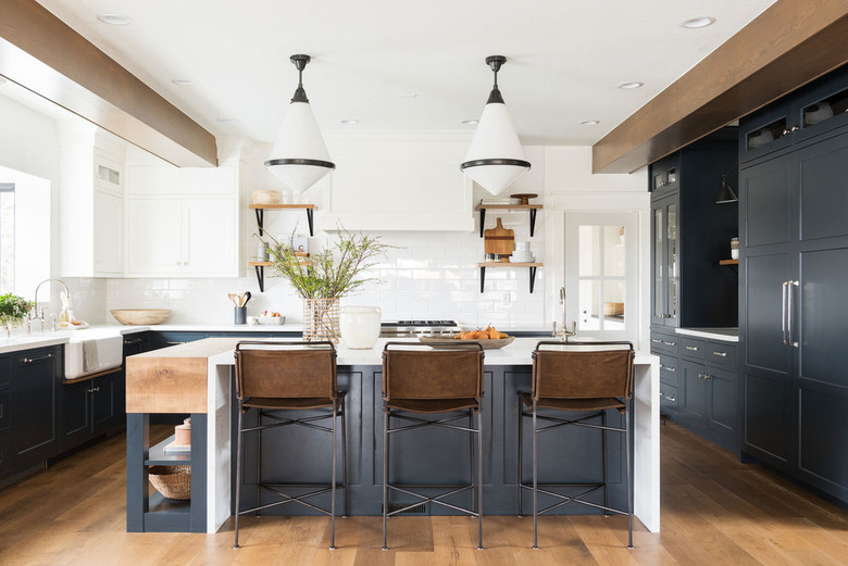 navy blue kitchen color idea with blue cabinets and island and wood ceiling beams