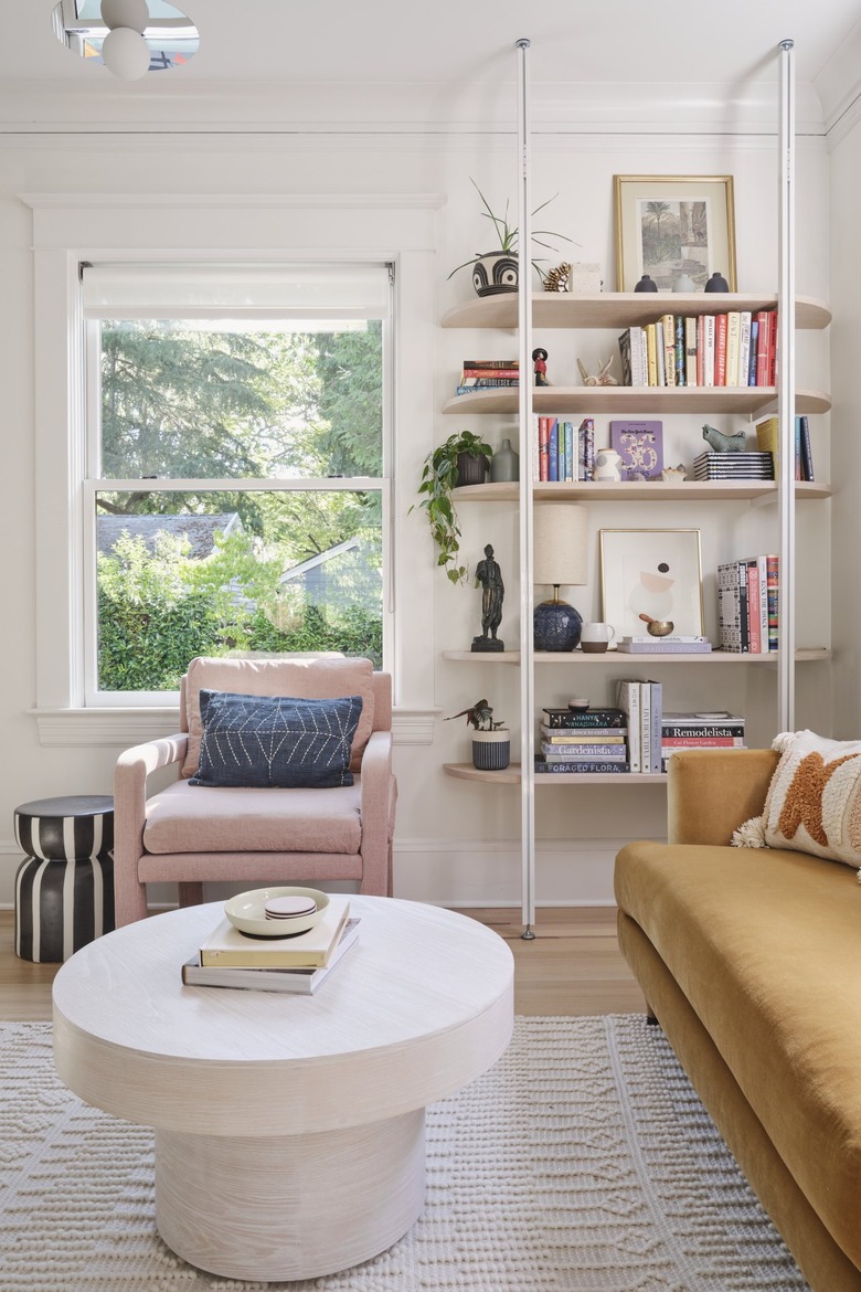 TV room with colorful furnishings and shelving unit for books