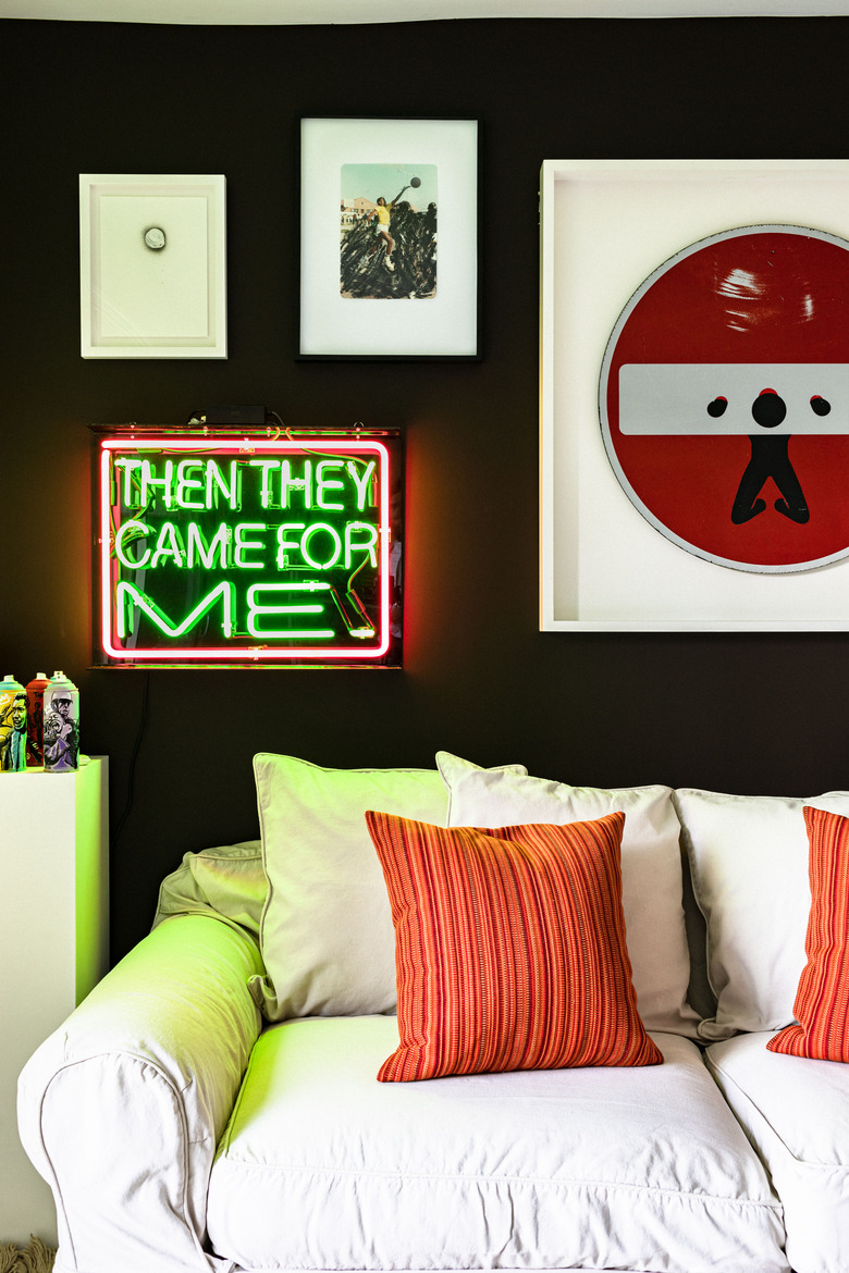 White couch with striped orange pillows